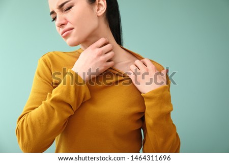 Young woman with skin allergy on color background Royalty-Free Stock Photo #1464311696