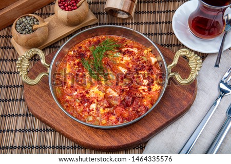 Traditional turkish food menemen, made by eggs, sausage (sucuk) and tomatoes. Royalty-Free Stock Photo #1464335576