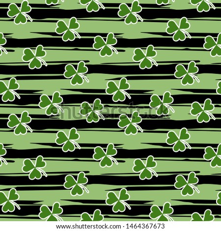 Seamless pattern with green clover on grunge stripes