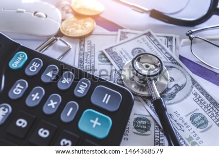Stethoscope with calculator on dollar - Financial analysis. business concept.