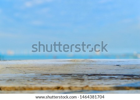 Close-up photos of wood floors and background are the sea and the sky.