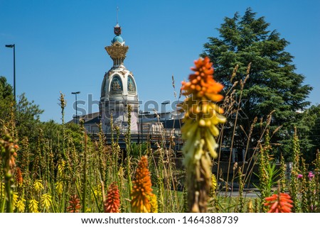 Tour Lu in Nantes on a Sunny Summer Day with Green Vegetation and Orange Common Torch Lilly Flowers Royalty-Free Stock Photo #1464388739