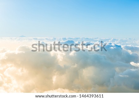 Airplane view of beautiful landscape with blue sky, gold colored clouds and ocean at sunny day Royalty-Free Stock Photo #1464393611