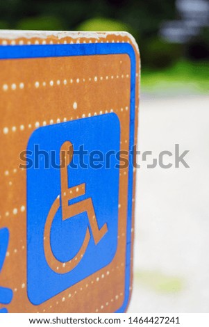 Sign indicating handicapped zone. japanese language 'wheelchair access via here'