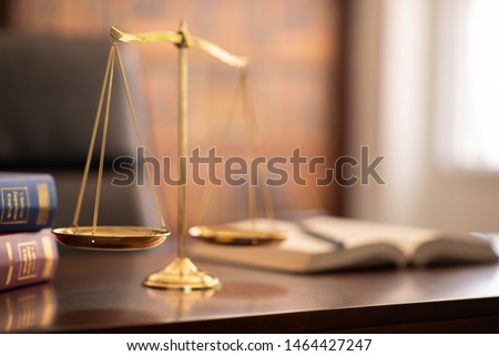 justice legal and jurisprudence concept.scales of justice and law books on lawyer desk at law firm. Royalty-Free Stock Photo #1464427247