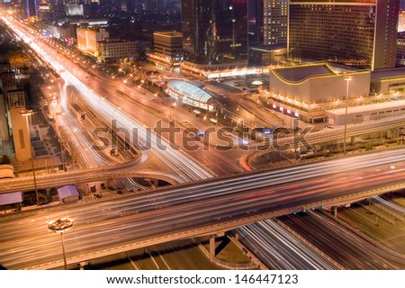 the light trails on the modern building background in beijing china.