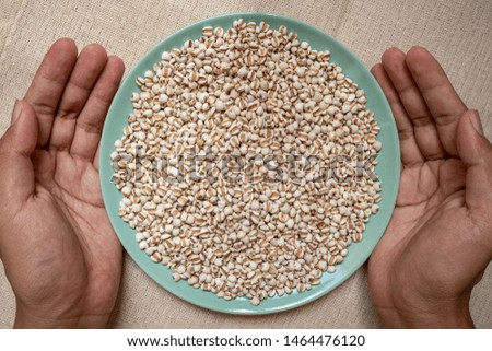 Picture of millet or job’s tears in hand is cereal and is food because it is used to advertise food.