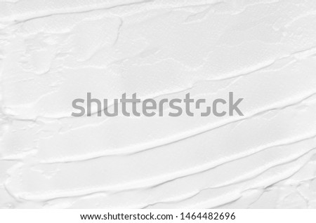 Texture of white face cream smeared on a white background. Cosmetic texture, face and body care. Royalty-Free Stock Photo #1464482696