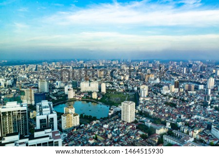 Hanoi cityscape taken from an Observation Deck around sunset with bule sky and few white clouds.