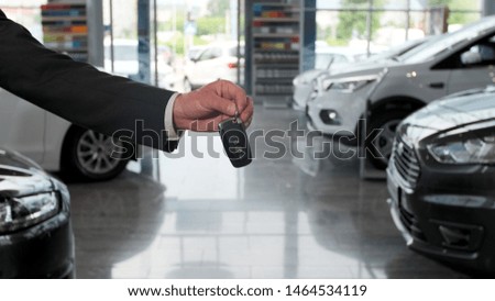 Salesman dealer hold a car keys.