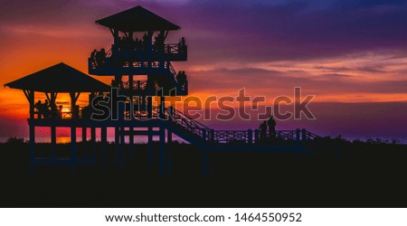 Silhouette of the crowd at the view point pavilion with twilight sunset and wonderful sky background.Famous landmark of Pattani Province,Thailand.Pictures offer a beautiful place for lovers of travel.