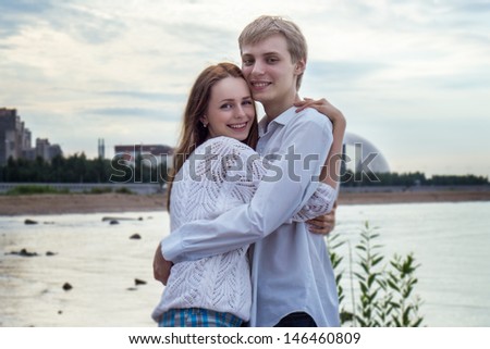 Sweet girl and boy together on the beach