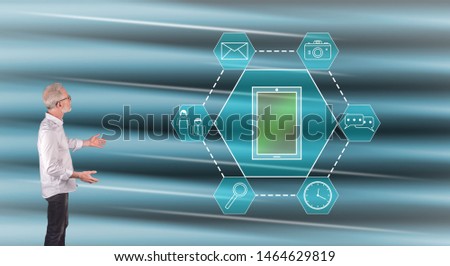 Businessman showing an apps concept on a wall screen