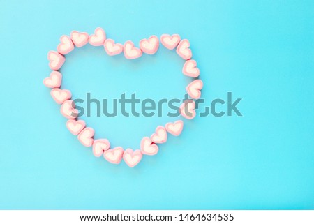 marshmallow snack in heart shape. Decorate design Love on blue background.  
