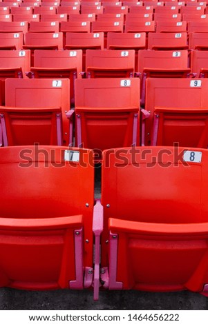 Row of red folding chairs in a stadium. Sport concept.