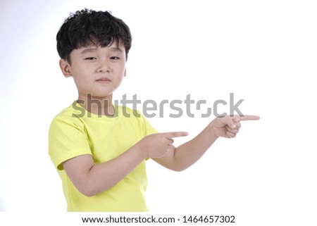 Asian little cute boy pointing something, isolated on white background