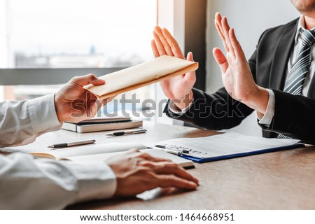 Corruption and Bribery,Businessman manager refusing receive money from Business man passing money dollar bills to deal contract Royalty-Free Stock Photo #1464668951