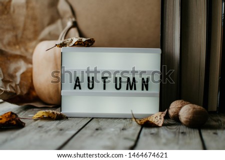 White lightbox. Classic banner for your projects or advertising. White lightbox on the wooden table with autumn background. 
