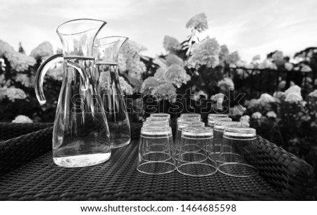 Jug of water with glasses - black and whote picture