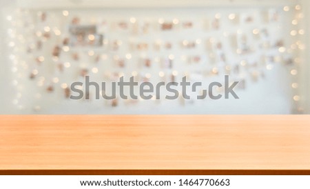 Wood table in blurry background of modern restaurant room or coffee shop with empty copy space on the table for product display mockup. Interior restaurant counter design concept.
