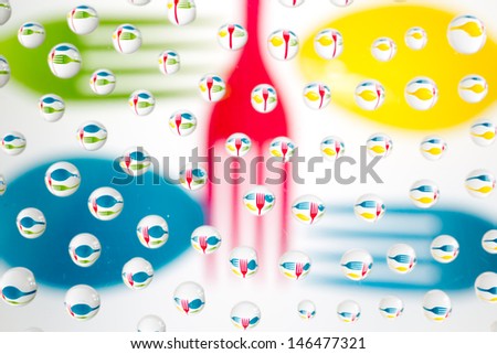waterdrops picturing colored cutlery