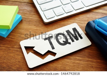 Total Quality Management TQM concept.Report on a desk. Royalty-Free Stock Photo #1464792818