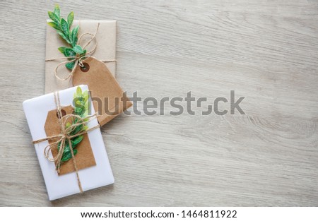 Eco style gift wrapping. Composition with gift boxes decorated with grin branch and rose. Top view, flat lay