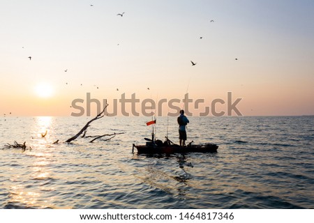 Aerial Drone shot of a Young Man Kayak Fishing at Sunrise in Canada