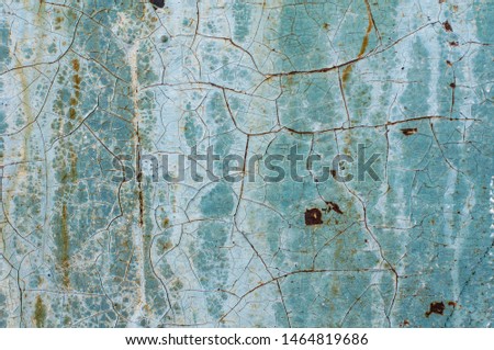 Old metal door as art. The oxidation process drew orange and black veins on a gray and blue background. Dark spots - holes in the iron. Natural aging of the wall. Old background.