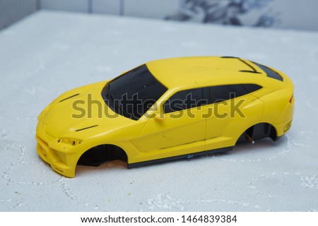 Not wheelchairs yellow baby car . Closeup of a yellow baby car on a white background . Broken yellow toy car