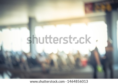 Motion blurred passengers walking and waiting at terminal gate in American airport