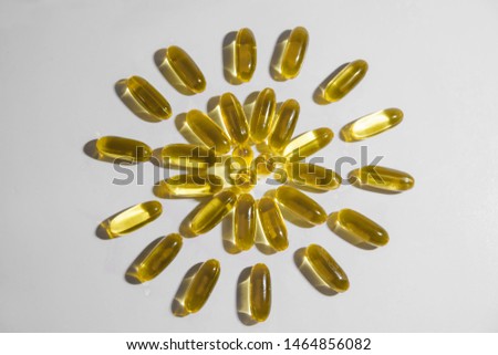 yellow transparent capsules on white background