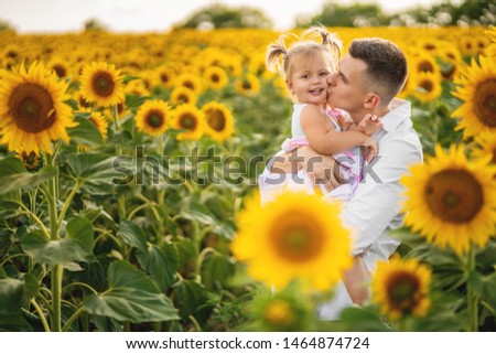 Happy young father kissing his little daughter outdoors 