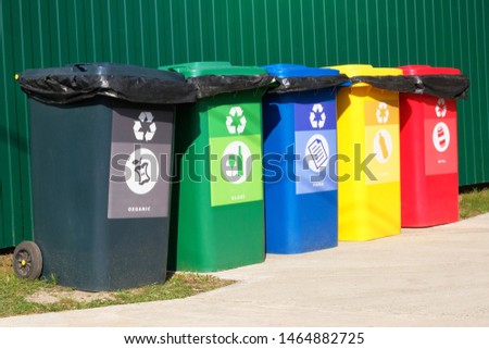 Separate garbage collection. Waste recycling concept. Containers for metal, glass, paper, organics, plastic for further processing of garbage. Side view.