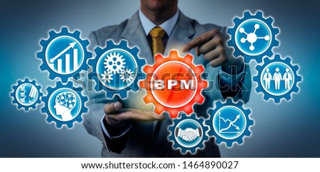 Unrecognizable businessman is highlighting a BPM application icon in a virtual gear train. Concept for business process management, operations management, enabling technology, predictability. Royalty-Free Stock Photo #1464890027