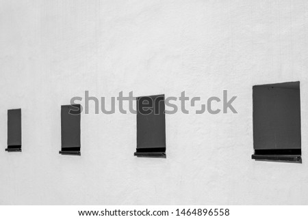White concrete background with three windows, Abstract geometric pattern, Old outdoor building wall, Can be used as background for display or montage your products.