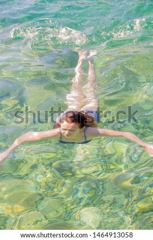 Young girl swiming in the beautifull Adriatic  sea