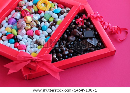 Luxury,Colorful Almond Candies and Madlen Chocolate in red color carton box with red bow and ribbon.Unedit,original,as taken  conceptual image for celebrations.