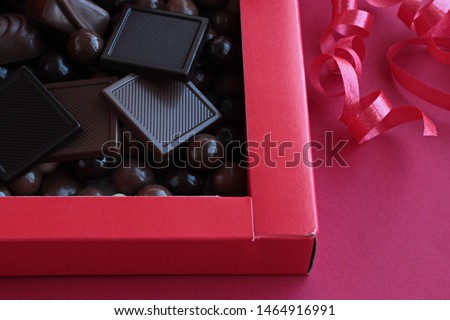 Luxury,Madlen and Dark Ball Chocolate in red color carton box with red  ribbon.Unedit,original,as taken, conceptual image for celebrations.