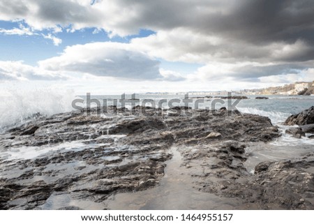 waves breaking on the rocks on a beach in benalmadena spain