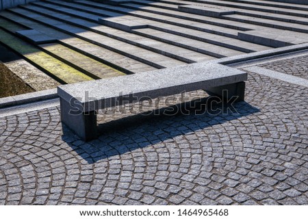 pedestrian street with stone bench 