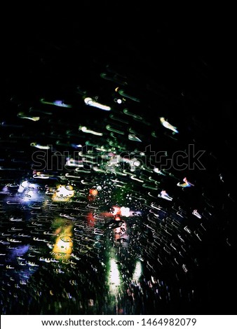 splashes of rain in a car's glass like the art of reflection