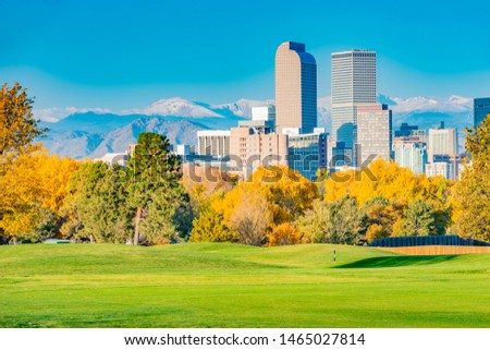 Scenic of Denver Colorado skyline. City Park and Rocky Mountains. Located in Denver, Colorado, USA.