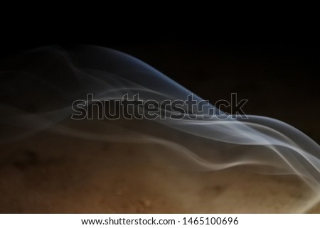 smoke in a beautiful shape in a dark room
