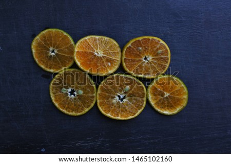 orange fruit slices on black background