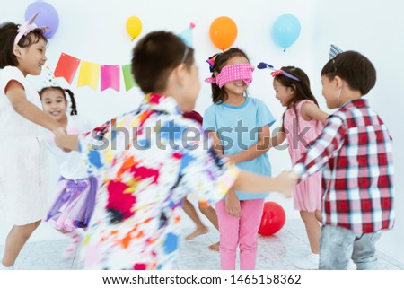 Asian Kids Playing Cheerful And Smiling Fun celebration party At living room. Birthday or Childhood, Holidays, Friendship and Celebration Concept
