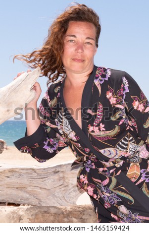 Smiling brunette woman happy relaxing on beach holidays portrait healthy lifestyle caucasian girl