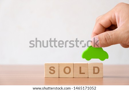 Vehicle, transportation investment and car mortgage financial concept. Hands holding wooden car and wood cube block with RENT word. 