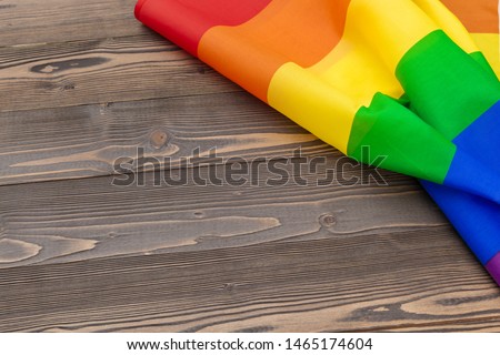 Gay pride flag on wooden table shot in studio 
