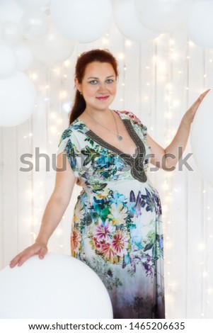 Portrait of a beautiful pregnant woman in the room